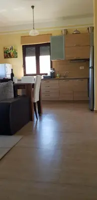 a kitchen with a table and a counter top at Villa Persik in Utjeha