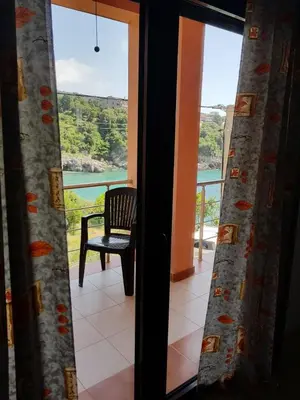 a room with a window with a chair and a view at Villa Persik in Utjeha