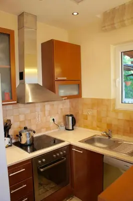 a kitchen with a sink and a stove top oven at Cezar Holiday Home in Sveti Stefan