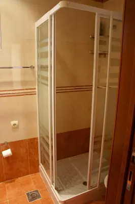 a shower stall with glass doors in a bathroom at Cezar Holiday Home in Sveti Stefan