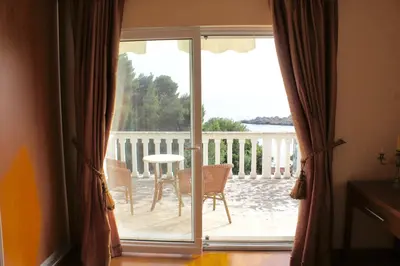 a sliding glass door with a view of a patio at Cezar Holiday Home in Sveti Stefan