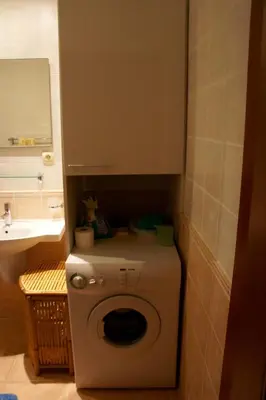 a small bathroom with a washing machine and a sink at Cezar Holiday Home in Sveti Stefan