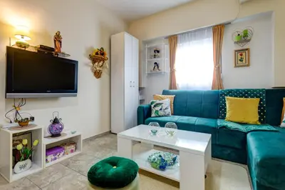 a living room with a blue couch and a table at Apartment Natasha in Budva