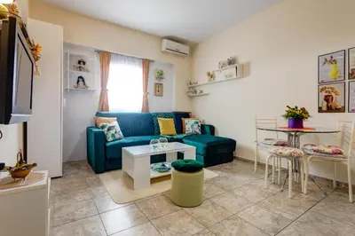 a living room with a blue couch and a table at Apartment Natasha in Budva