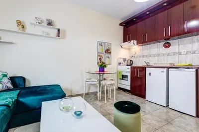 a living room with a couch and a kitchen at Apartment Natasha in Budva