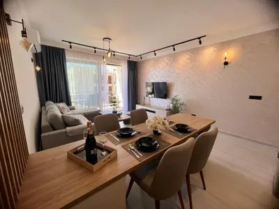 a dining room with a table and chairs and a couch at Apartment Ema Star in Utjeha