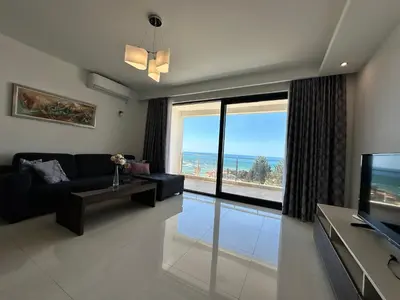 a living room with a view of the ocean at Apartment Ema Star in Utjeha