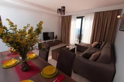 a living room with a couch and a table at Apartment Ema Star in Utjeha