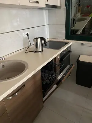 a kitchen counter with a sink and a mirror at Apartment Ema Star in Utjeha