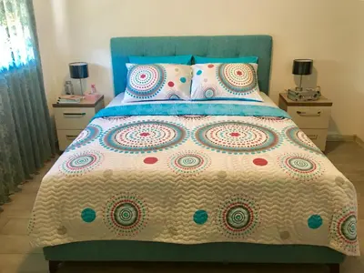 a bedroom with a bed with a colorful bedspread and pillows at Apartment Ema Star in Utjeha