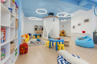 a childs play room with a table and chairs at Dukley Hotel & Resort in Budva