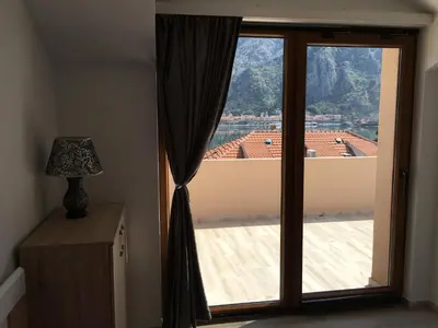a large window with a view of a roof at Apartmani Mizdrak in Kotor