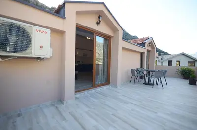 a patio with chairs and a fan on a house at Apartmani Mizdrak in Kotor