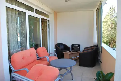 a room with two chairs and a table and a window at Apartments Stevanović in Dobra Voda