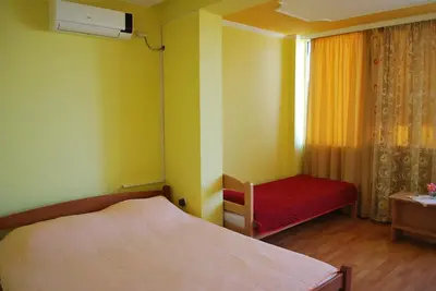 a small bedroom with a bed and a window at Apartments Stevanović in Dobra Voda