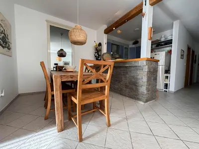a kitchen with a wooden table and chairs at Apartment Radovic in Sveti Stefan