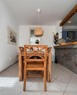 a dining room with a table and a chair at Apartment Radovic in Sveti Stefan