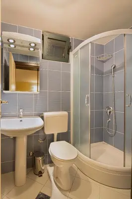 a bathroom with a toilet and a sink and a shower at Apartments Mika in Budva