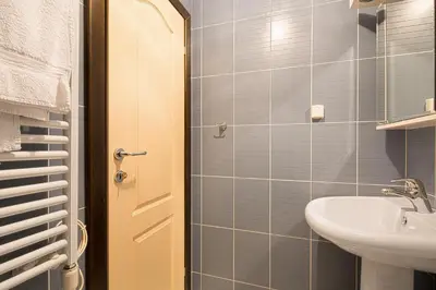 a small bathroom with a sink and a shower at Apartments Mika in Budva