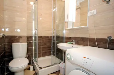 a small bathroom with a toilet and a sink at Apartments Residence Dj in Petrovac na Moru