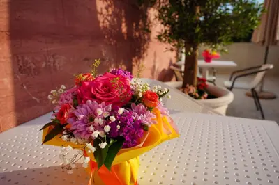 a bouquet of flowers sitting on top of a table at Apartments Residence Dj in Petrovac na Moru