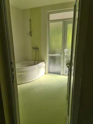 a bathroom with a bath tub and a window at Villa Nadija in Čanj