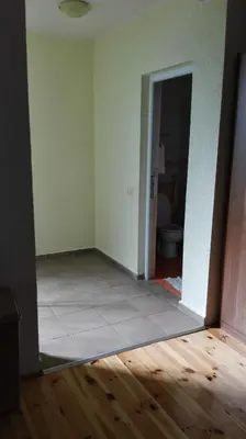 an empty room with a tile floor and a bathroom at Villa Nadija in Čanj