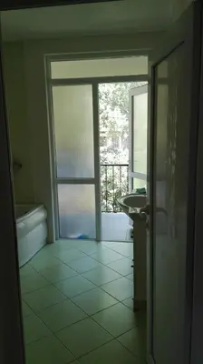 a bathroom with a tub and a sink and a window at Villa Nadija in Čanj