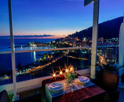 a table on a balcony with a view of the city at Luxury Apartment Valentina in Budva