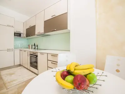 a bowl of fruit on a table in a kitchen at Luxury Apartment Valentina in Budva