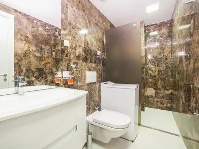 a bathroom with a toilet and a sink and a mirror at Luxury Apartment Valentina in Budva