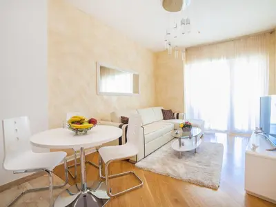 a living room with a white couch and a table at Luxury Apartment Valentina in Budva