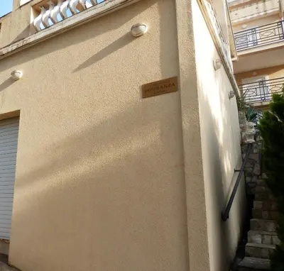 a door with a sign on the side of a building at Apartments Esperanza in Utjeha