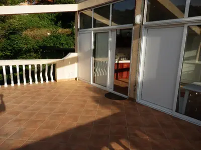a patio with sliding glass doors on a house at Apartments Esperanza in Utjeha