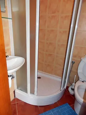 a shower in a bathroom with a sink and a toilet at Apartments Esperanza in Utjeha