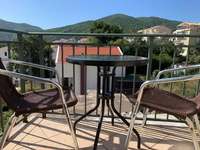 a black table and two chairs on a balcony at Korolev Apartment in Budva