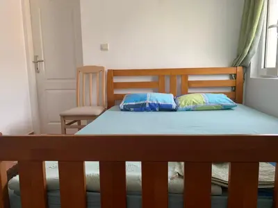 a bed with two pillows on it in a room at Korolev Apartment in Budva