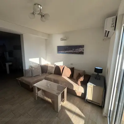 a living room with a couch and a table at Apartman Aleksandar in Ulcinj