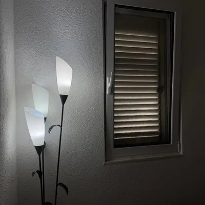 two lights on a wall next to a mirror at Apartman Aleksandar in Ulcinj