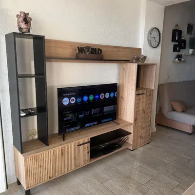 a entertainment center with a flat screen tv in a living room at Apartman Aleksandar in Ulcinj
