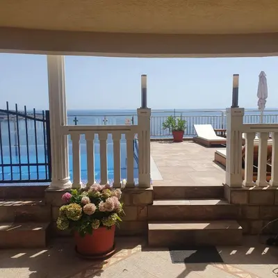 a balcony with stairs and a view of the ocean at Villa Apartmani Anja in Dobra Voda