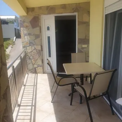 a patio with a table and chairs on a balcony at Villa Apartmani Anja in Dobra Voda