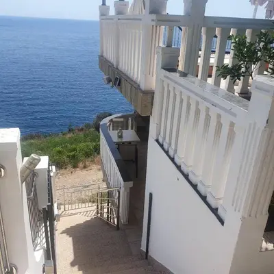 a white balcony with a view of the ocean at Villa Apartmani Anja in Dobra Voda