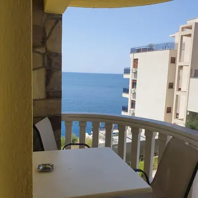 a balcony with a table and a view of the ocean at Villa Apartmani Anja in Dobra Voda