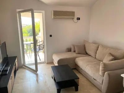 a living room with a couch and a table at Apartment Talas in Budva