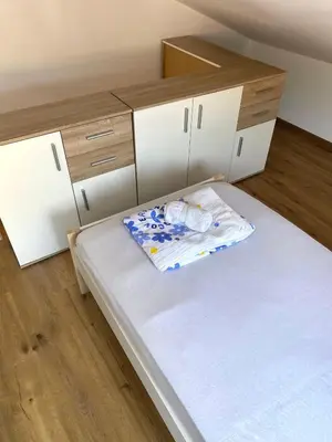 a small room with a bed and cabinets at Apartment Talas in Budva