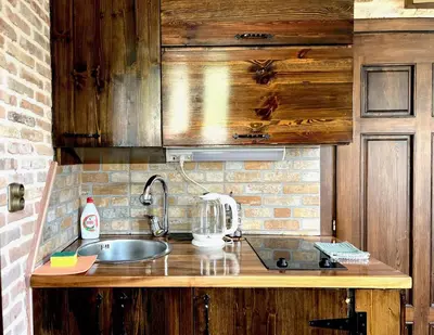a kitchen with a sink and a mixer on a counter at Una apartments in Kotor