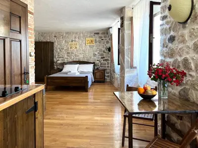 a room with a bed and a table with fruit on it at Una apartments in Kotor