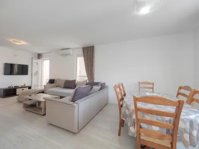 a living room with a bed and a couch and a table at Family Three bedroom Apartment Brando in Budva