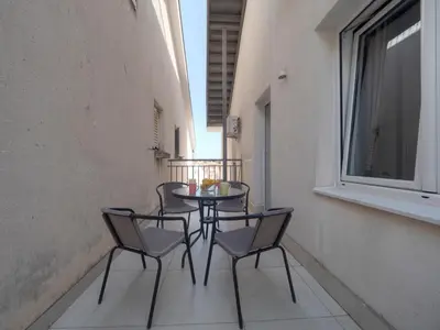 a table and chairs sitting on a balcony at Family Three bedroom Apartment Brando in Budva